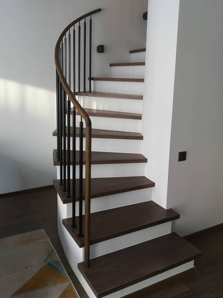 spiralės formos laiptinė su pakopomis ir turėklu